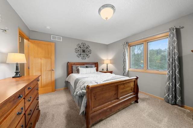 carpeted bedroom with a textured ceiling