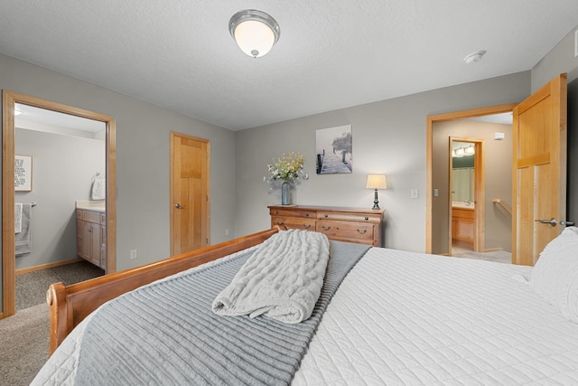 bedroom with connected bathroom, light carpet, and a textured ceiling