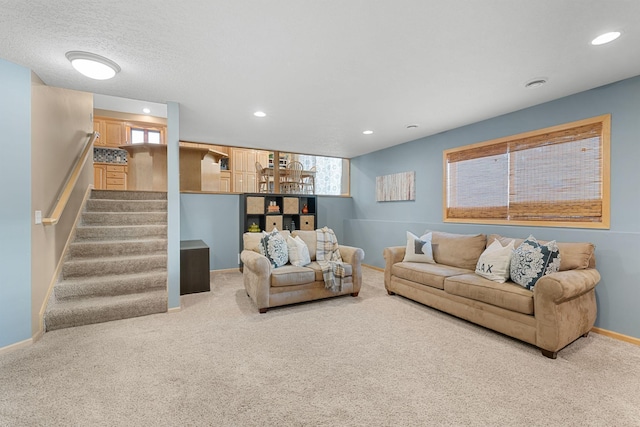 carpeted living room with a healthy amount of sunlight and a textured ceiling