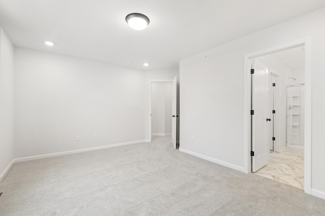 unfurnished room featuring recessed lighting, baseboards, and light colored carpet