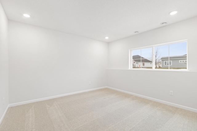 carpeted spare room with baseboards and recessed lighting