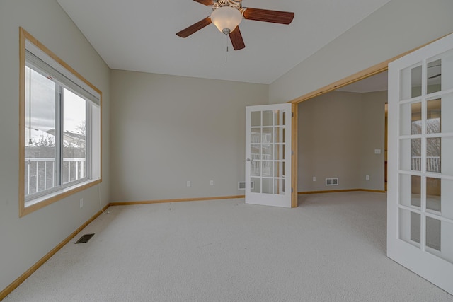 spare room with french doors, ceiling fan, and carpet flooring