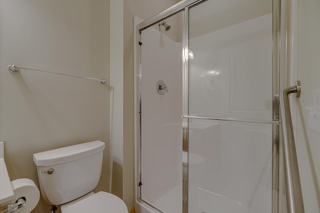 bathroom with walk in shower and toilet