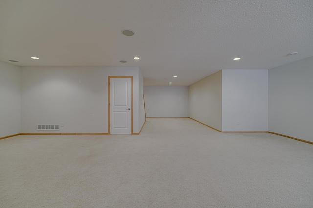 carpeted spare room featuring a textured ceiling