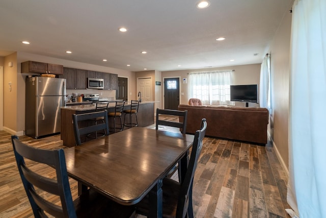 dining room featuring baseboards, dark wood-style flooring, and recessed lighting