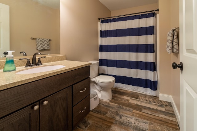 bathroom featuring vanity, a shower with shower curtain, wood finished floors, and toilet