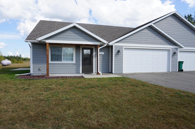 single story home featuring an attached garage, aphalt driveway, a front yard, and a shingled roof