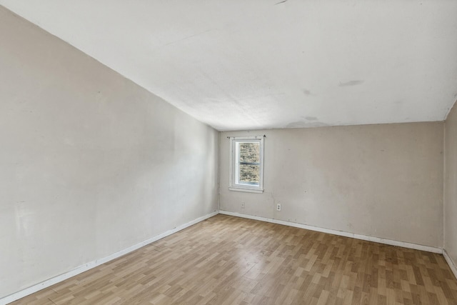 unfurnished room featuring light wood finished floors and baseboards