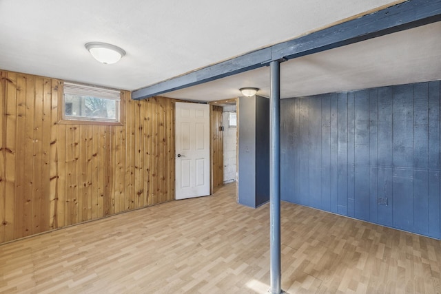 basement with wood walls and wood finished floors