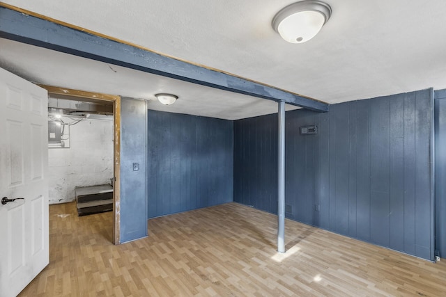 finished basement with wood walls and wood finished floors