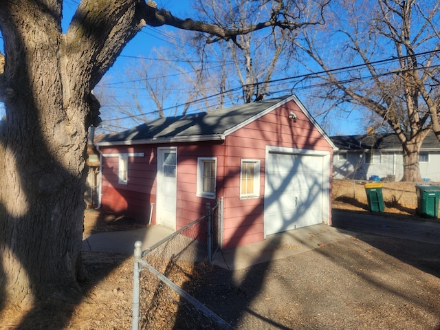 view of home's exterior with a garage and an outdoor structure