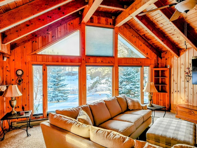 carpeted living room with vaulted ceiling with beams, ceiling fan, wood ceiling, and wood walls