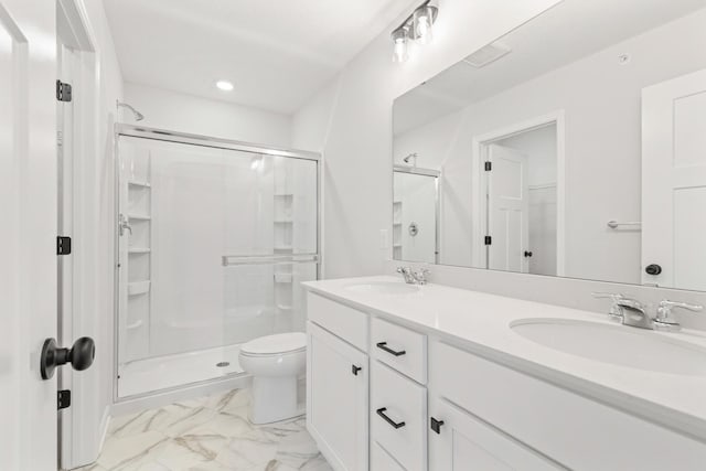 bathroom featuring vanity, toilet, and an enclosed shower