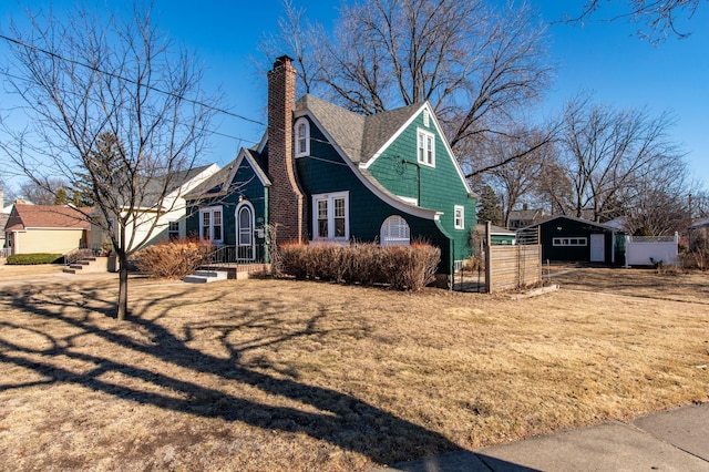 view of front of property with an outbuilding and a front lawn