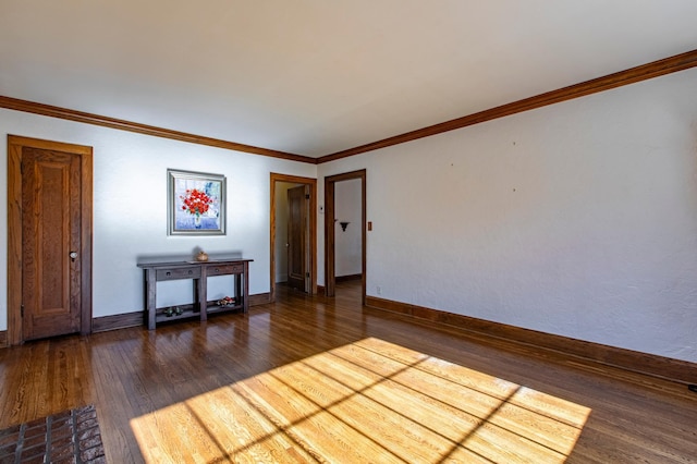 unfurnished room featuring ornamental molding and dark hardwood / wood-style flooring