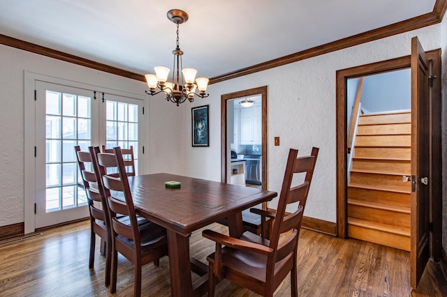 dining room featuring a notable chandelier, crown molding, french doors, and hardwood / wood-style flooring