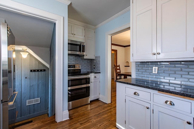 kitchen featuring crown molding, dark wood-type flooring, stainless steel appliances, and white cabinets