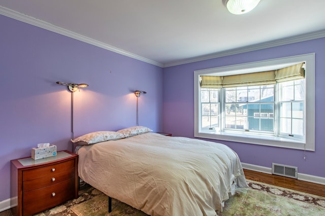 bedroom featuring hardwood / wood-style flooring and crown molding