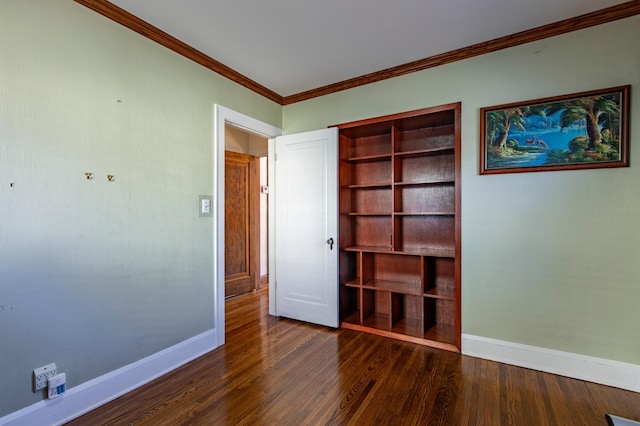 unfurnished bedroom featuring dark hardwood / wood-style flooring, ornamental molding, and a closet