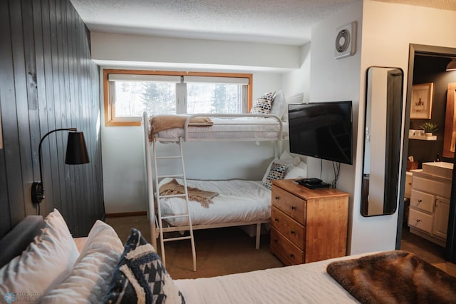 carpeted bedroom featuring a textured ceiling