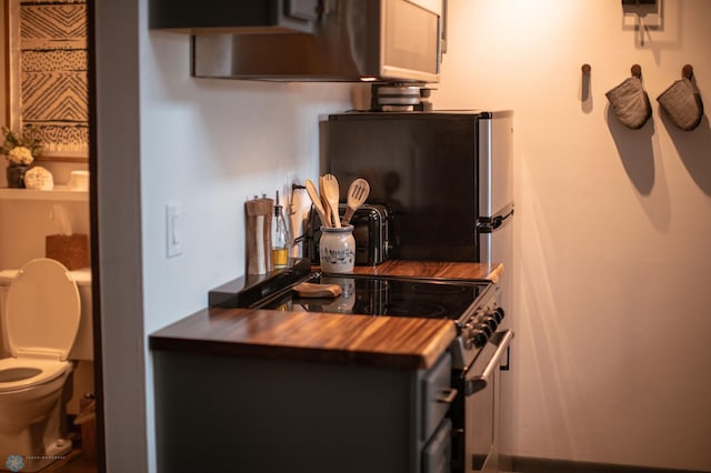 kitchen featuring wood counters and appliances with stainless steel finishes