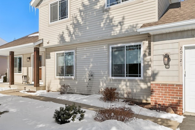 view of snow covered property entrance