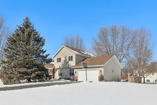 view of snowy exterior with a garage