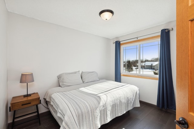 bedroom with dark wood-type flooring