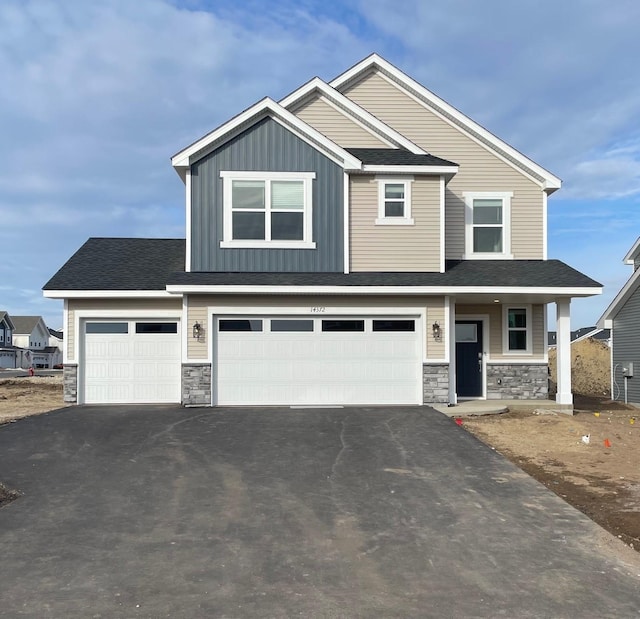 craftsman inspired home with a garage and a porch