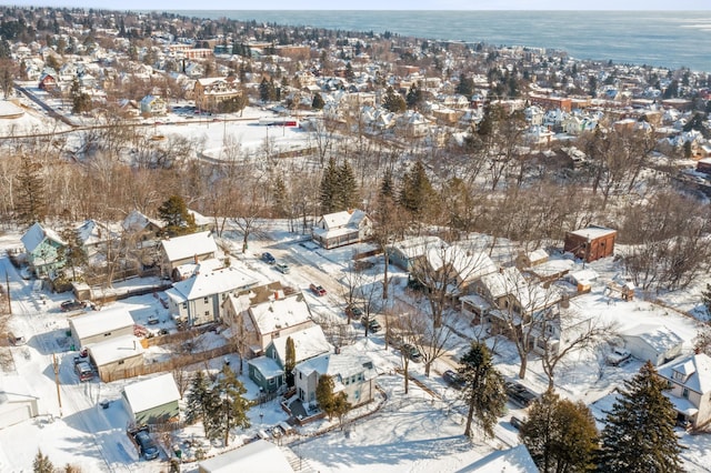 snowy aerial view featuring a water view