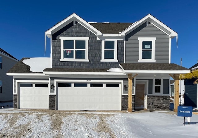 view of front of house featuring a garage, stone siding, and a shingled roof