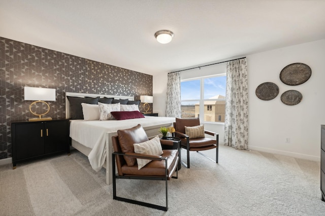 bedroom featuring baseboards, light colored carpet, and wallpapered walls