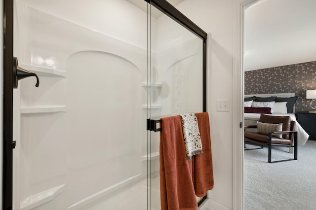 ensuite bathroom featuring a shower stall, ensuite bathroom, and wallpapered walls