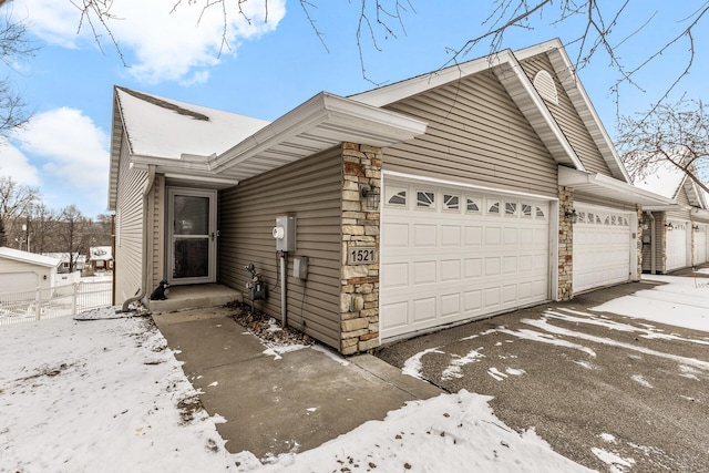 view of snow covered exterior featuring a garage