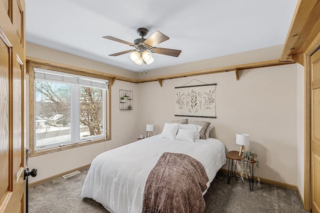 bedroom featuring ceiling fan and dark colored carpet