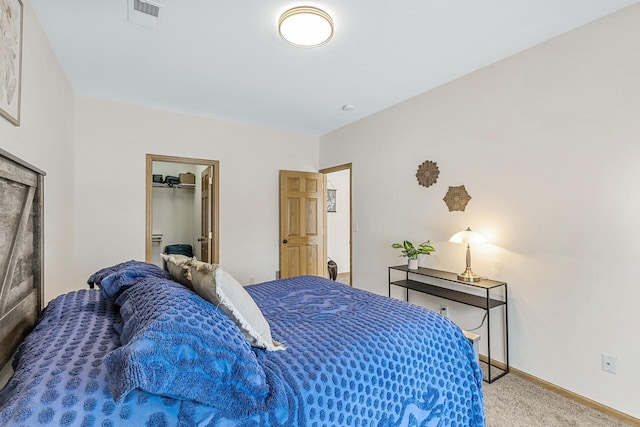 bedroom featuring a spacious closet and carpet floors