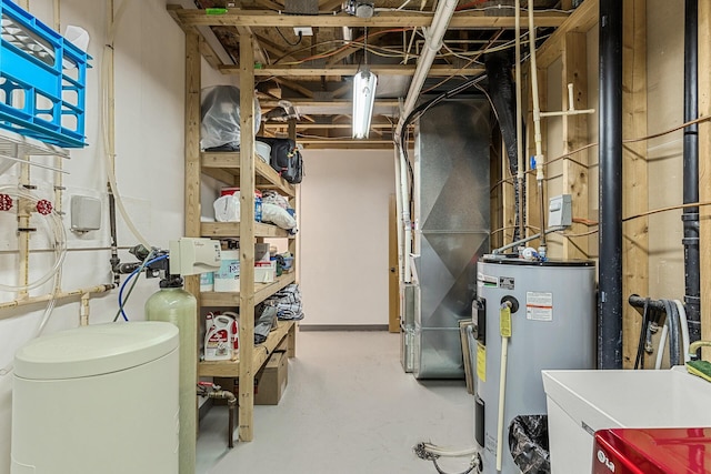 utility room featuring electric water heater and sink