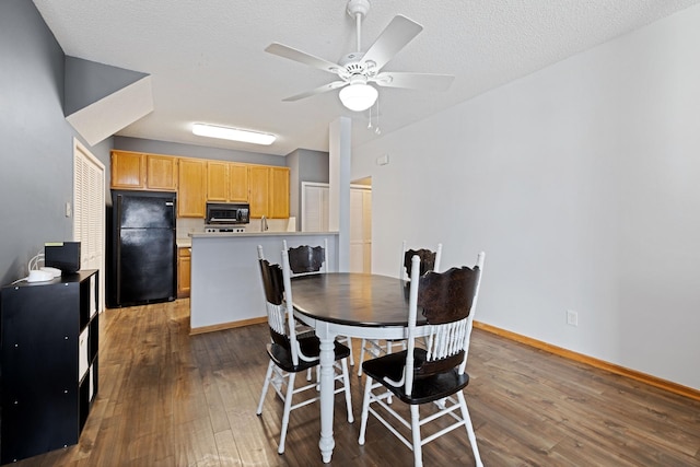 dining area with ceiling fan, dark hardwood / wood-style flooring, and a textured ceiling