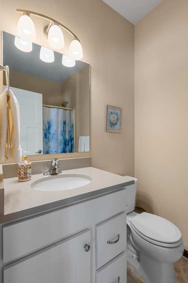 bathroom featuring a shower with shower curtain, vanity, and toilet