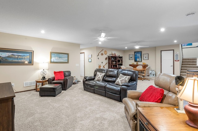 carpeted living room with ceiling fan