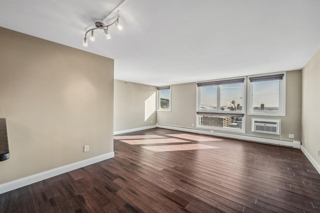 unfurnished living room featuring wood-type flooring, a baseboard heating unit, and a wall unit AC