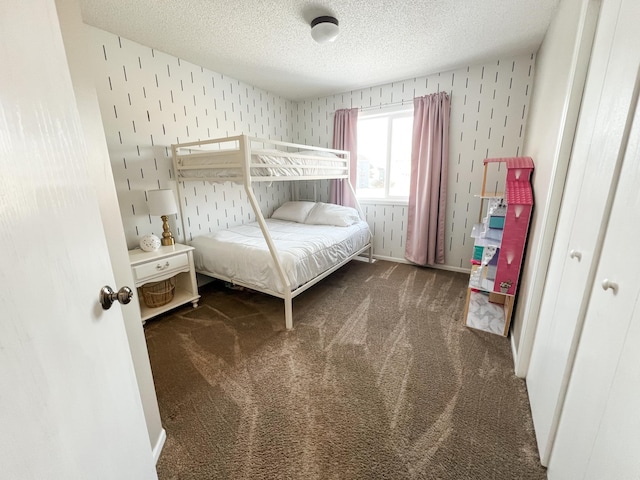 bedroom with a textured ceiling and carpet flooring