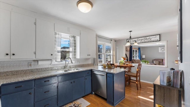 kitchen featuring blue cabinets, sink, white cabinetry, hanging light fixtures, and dishwasher