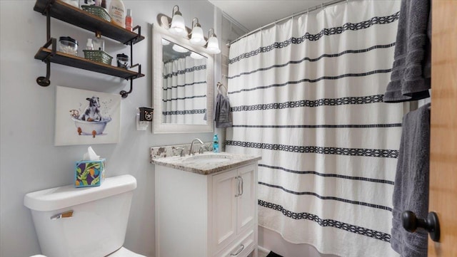 bathroom with vanity, toilet, and walk in shower