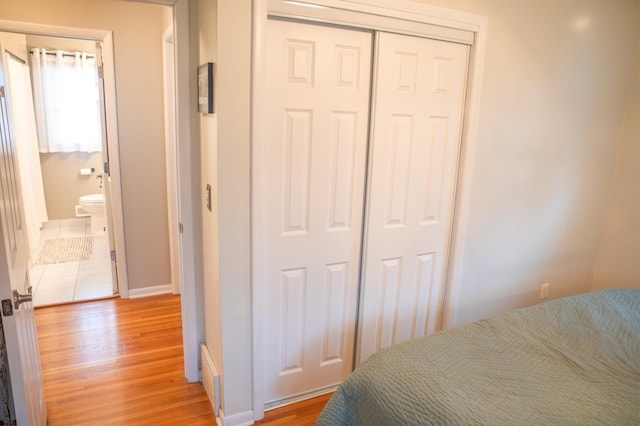 bedroom featuring hardwood / wood-style flooring and a closet