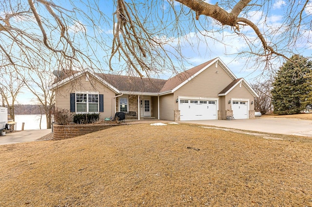 ranch-style house featuring a garage and a front lawn