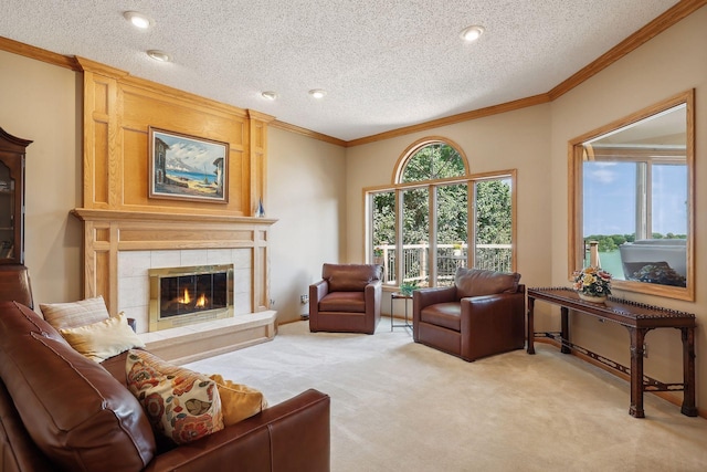 carpeted living room with ornamental molding, a textured ceiling, a tile fireplace, and plenty of natural light