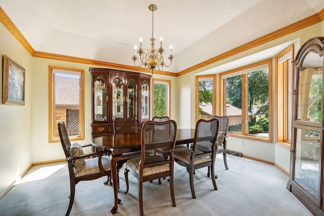 carpeted dining area with crown molding, a textured ceiling, and a chandelier