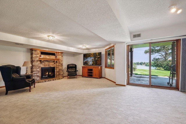 unfurnished living room with a brick fireplace, a textured ceiling, and carpet flooring