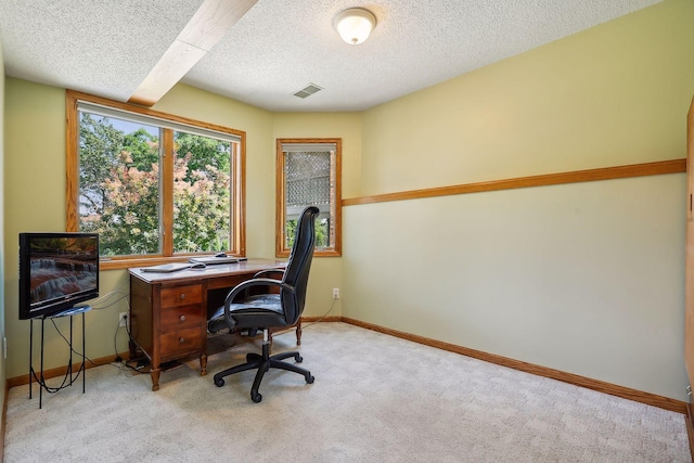 carpeted home office with a textured ceiling